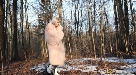 Hot blonde Vasya takes a piss in the woods against a tree in a winter coat