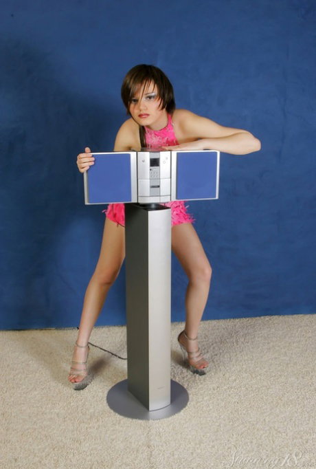 Barely legal brunette Lara O hits upon tempting poses while getting naked
