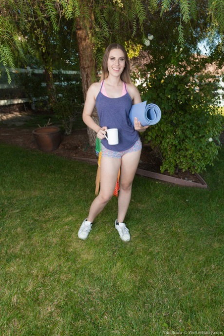 Teenage model Niki Snow shows her nice ass and hairy twat outdoors