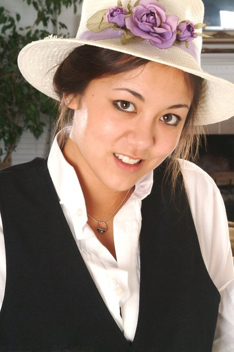 Cute Asian amateur Tiffany posing in a hat while exposing small breasts
