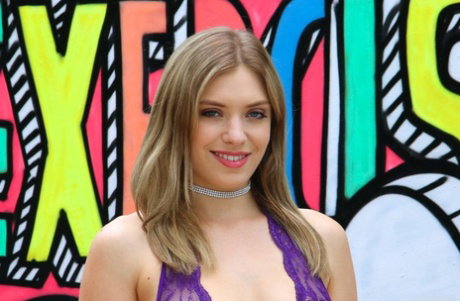 Adorable blondie in a purple outfit Giselle Palmer showing her curves