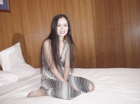 Long-haired Asian named Yuie undresses and masturbates on the table