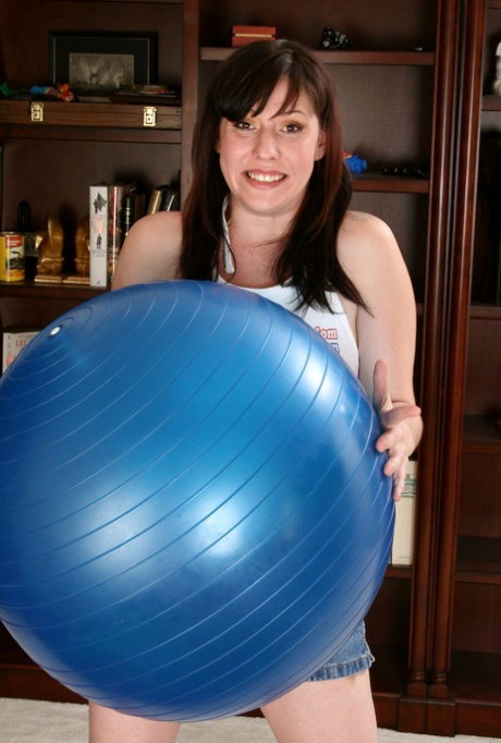Amateur chick Loni gets naked before touching her pussy on a yoga ball
