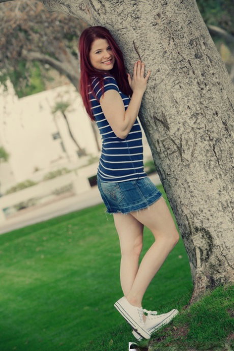 Natural redhead Mindy Corin exposes herself while in a public park
