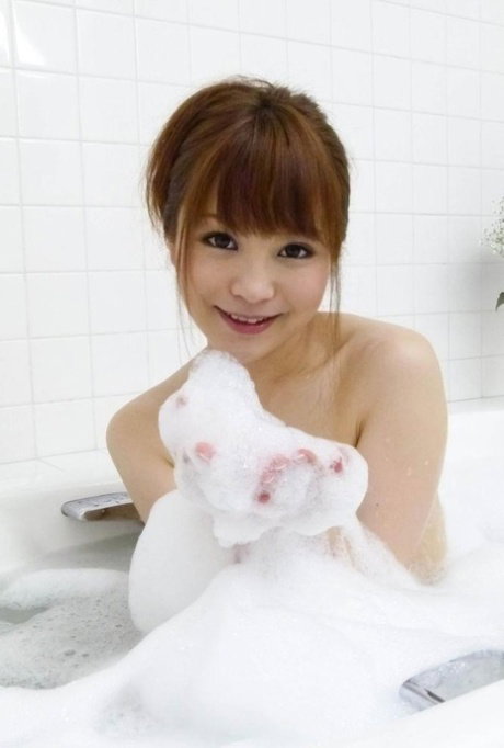 Adorable Japanese redhead Maomi Nagasawa gives oral sex during a bubble bath