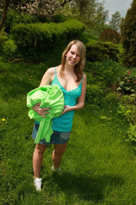 Playful European teen Sue A fingering and toying her pussy in the garden