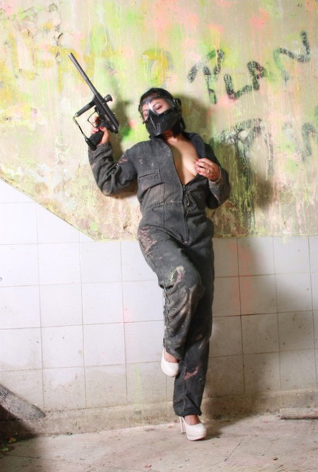 Colombian brunette Sandra Flores strips to her lingerie on the paintball field