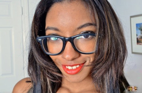 Black amateur Raven Wilde shows off the pink of her pussy with glasses on