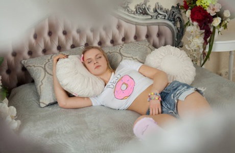 Nice teen Fabi gets completely naked on a bed while surrounded by balloons