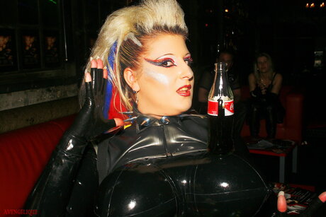 Blonde fetish model Avengelique poses in latex clothing and heels