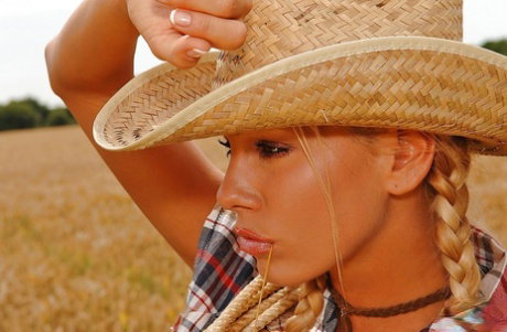 Hot cowgirl with pigtails taking off her shorts and masturbating her gash