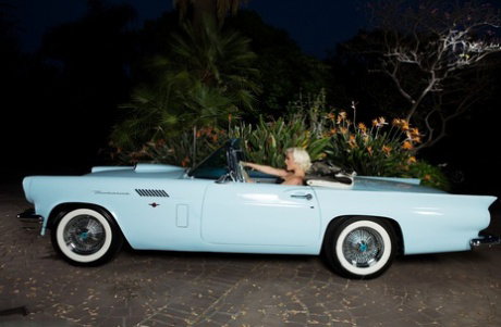 Platinum blonde centerfold Jenna Ivory strips naked and poses in a classic car