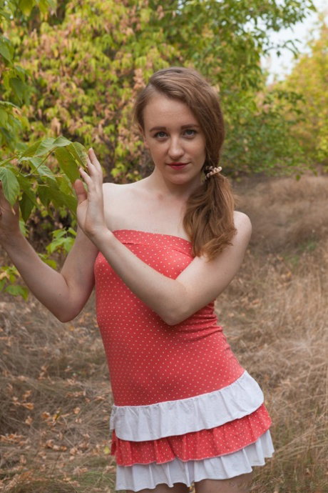 Petite Russian babe Emma Fantasy toying her hairy pussy with bananas outdoors