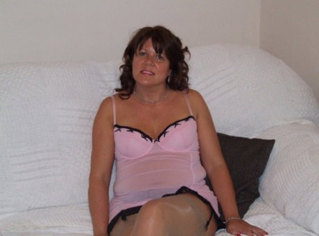 Mature brunette Cassandra Uk plays with her pussy while wearing lingerie