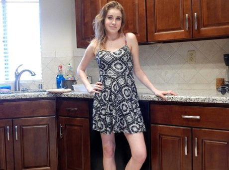 Adorable teen Kinsley shows her gorgeous breasts in a kitchen striptease