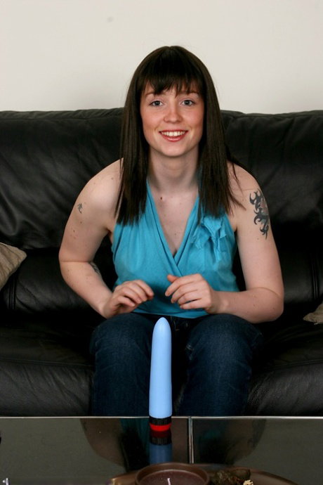 Hairy girl with a tattoo on her left arm masturbates with a sex toy