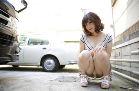 Cute Japanese girl Tomoka Sakurai exposes her trimmed pussy in a stairwell