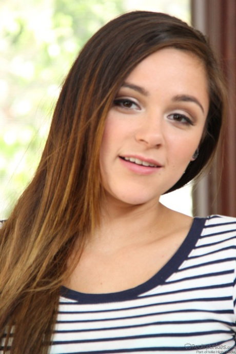 Brunette cutie Zoey Foxx reveals her perky natural tits with puffy nipples