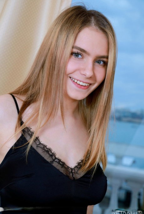 Beautiful blonde teen Dakota Pink discards a little black dress to pose nude