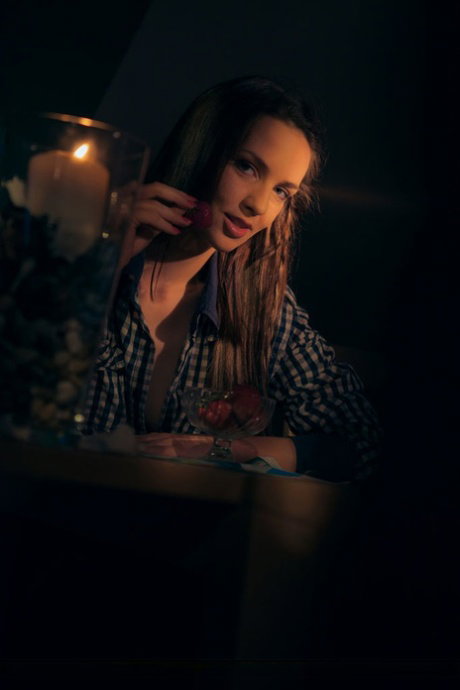 Pretty brunette Tandy gets naked by candlelight while eating strawberries