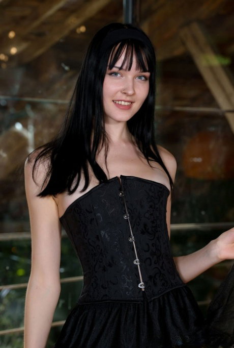 Dark haired teen Amelia Riven discards a black dress while getting bare naked