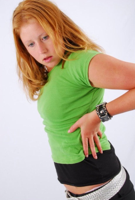 Natural redhead Judy models a double buckle cuff watch during SFW action
