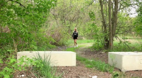 Distressed blonde takes an urgent piss on concrete blocks while out for a walk