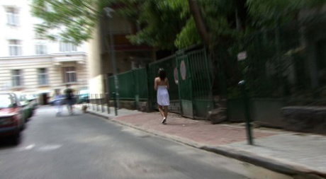 Strolling brunette gets her natural tits exposed by stranger in public assault