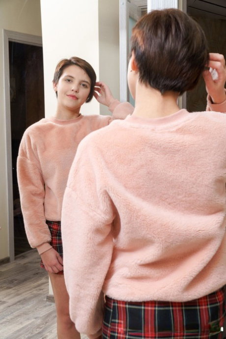 Short haired teen Alex Swon reveals her bald cunt and rubs it in red socks