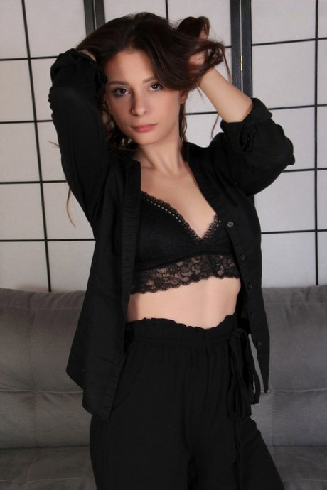 Beautiful girl Violet takes off her shoes while wearing sheer pantyhose