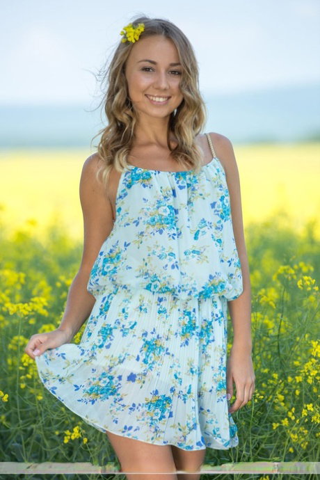 Sweet girl Linda A doffs her sun dress for great nude poses in a mustard field