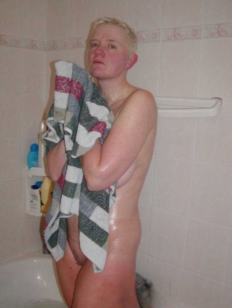 Older blonde woman Tiffany Pearl gets dressed after taking a bath