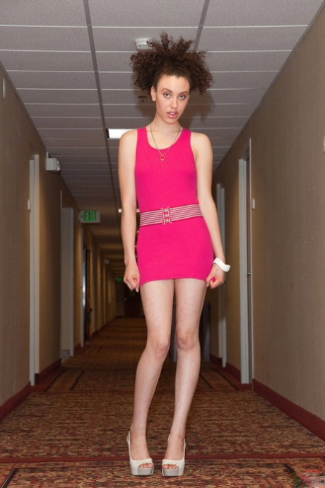Short pink dress gives possibility to see Loretta Woods' long legs