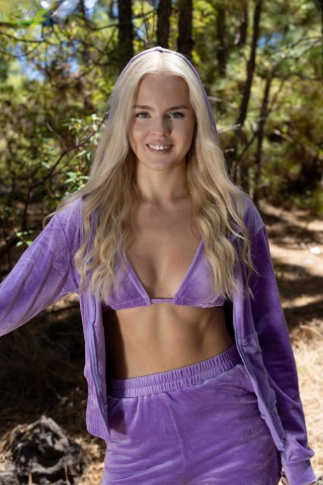 Beautiful blonde teen Decima gets naked in sneakers while in the woods