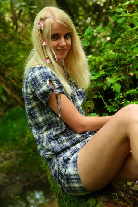 Sweet blonde teen Danielka undresses to masturbate next to a muddy brook