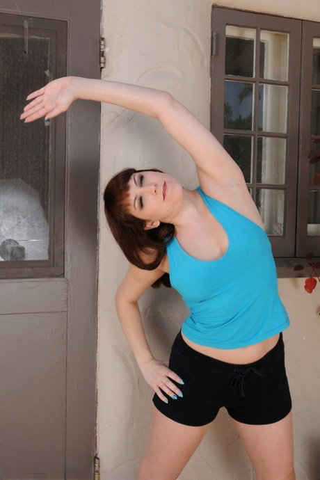 30 plus female Addie Juniper stretches out in shorts before getting bare naked
