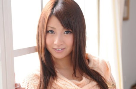 Japanese girl Hitomi Kitagawa snuggles up against her man in a thong