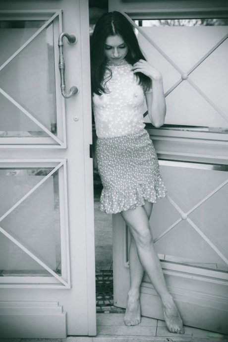 Young beauty with long hair releases her naked body from clothing