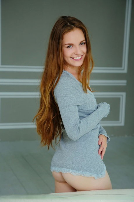 Beautiful redhead Sofie S takes off her sweater for great nude poses