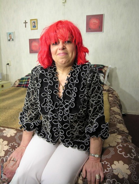 Red haired mature Coosje exposes her hard nips and plays with rubber dildo