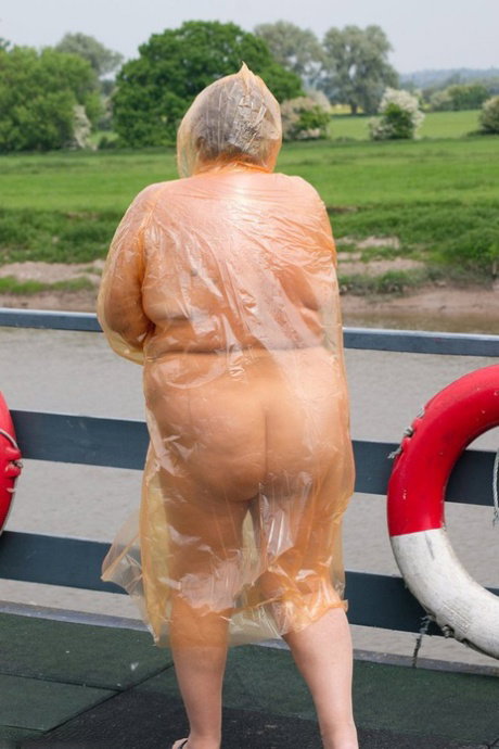 Obese oma Grandma Libby doffs a see-through raincoat to get naked on a bridge
