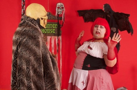 Overweight redhead Lexie Cummings gives an interracial blowjob at Halloween