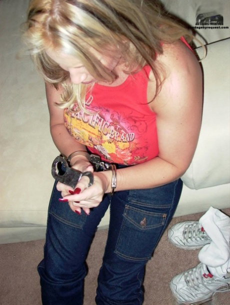 Older blonde Rachel Love paints her toenails while clothed and cuffed