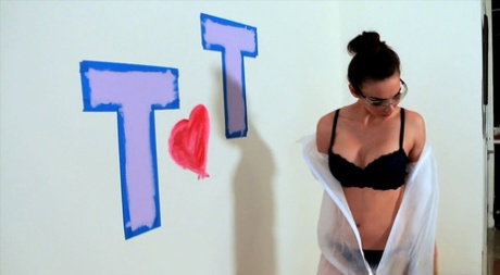 Tiffany Tyler wears protective glasses while covering herself in paint