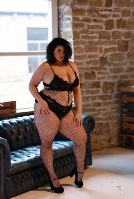 Fat model Kiki strips her bra, shows her boobs and poses in her fishnet tights