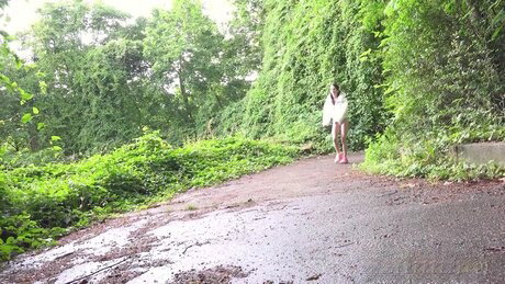 White girl Dragon Fruit takes a badly needed pee on a paved path