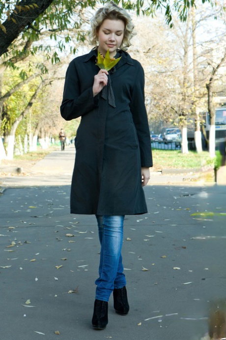 Cute young girl Zia works her her way free of her dress to pose in the nude
