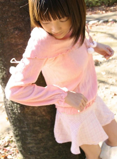 Cute Japanese girl Nana flashes her firm tits and cotton panties in the garden