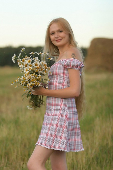 Pantyless babe Gerda A stripping and spreading her pussy in the hay