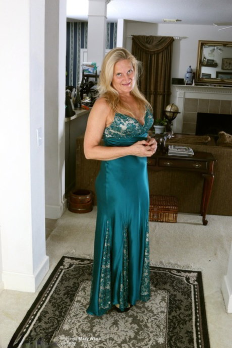 Mature blonde Mary Wana shows off her saggy tits during a sexy striptease